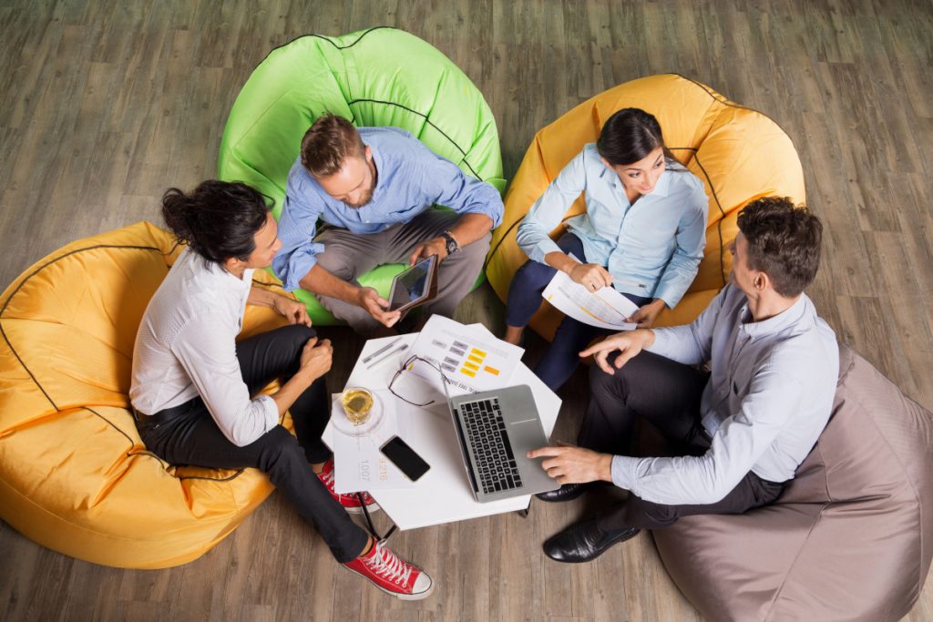 People Discussing Ideas and Sitting at Cafe Table